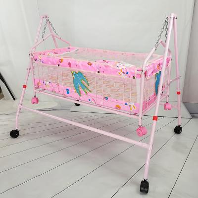 China Modern pink or blue color iron baby crib with net and mosauito wheels for sale