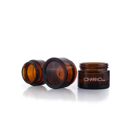 China Empty Cosmetic Elegant Spiral Mouth Care Cream 30g 50g Amber Glass Cream Jar Skin Shape With Black Plastic Cover for sale