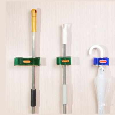 China Viable Wholesale Plastic Hanging Broom Holder Mount Two Wall Mount Two Holder Broom Brush Holder Hanger Storage Tools For Items for sale