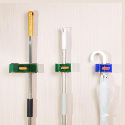 China Durable Punch Free Hanging Broom Holder Toilet Drain Plastic Broom Clip Clips Household Storage Adhesive Broom Hanger for sale