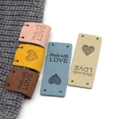 China 2x5CM Sustainable Heart Knitting Sew Label Hand Made With Love Leather Tags For Clothing Handmade Labels for sale