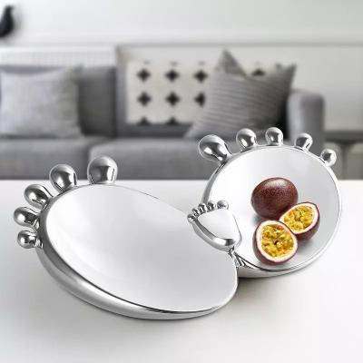 China Sustainable Nordic Porcelain Fruit Candy and Snack Tray Designed Footprint Unique Shape Craft Plate Silver Ceramic Dish for sale