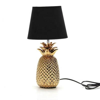 China Modern Home Decorative Black Fabric Shade Bedside Desk Lamp With Ceramic Pineapple Base for sale