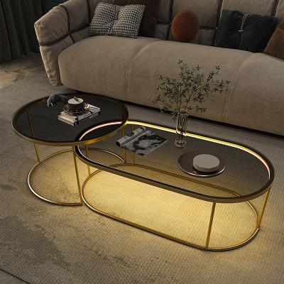 China Nordic light luxury home coffee table creative modern simple tempered glass living room oval tea table with lights for sale