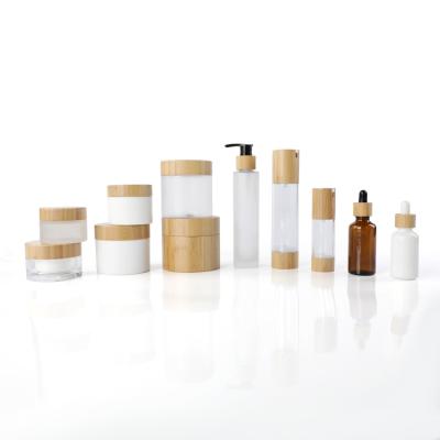 China Skin Care Cosmetic Packaging 10ml 20ml 30ml 50ml 80ml 100ml Clear Cosmetic Cream Jars Frosted Glass Bottles With Bamboo Dropper for sale