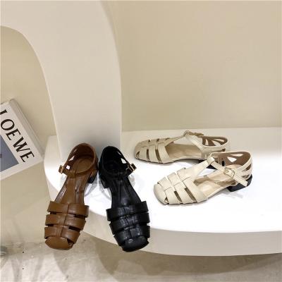 China 2022 fashion trend hot style Baotou fishbone braided hollow sandals women's word buckle flat comfortable beach sandals for sale