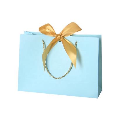 China Recycled Materials Gift Bag With Ribbon Festival Gift Bag Shopping Clothing Store Garment Packs Kraft Paper Package Shipping Bag for sale