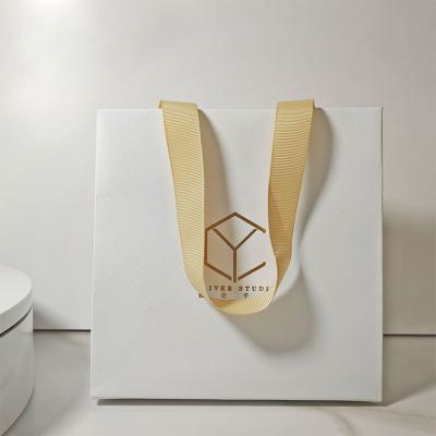 China Popular Style Handheld Ivory Board Paper Bag for Custom Boutique Clothing Packaging for sale