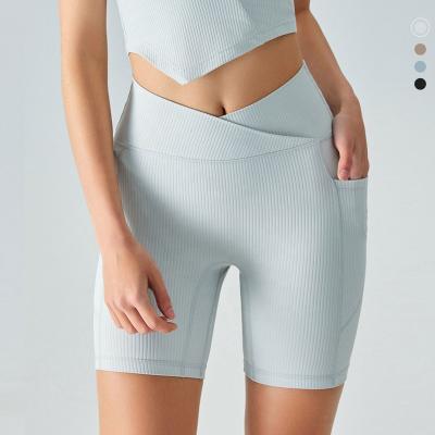 China Breathable High Waist Yoga Shorts For Women With Peach Ribbed Butt Pockets Control Tummy Lifting Recycling Shorts for sale