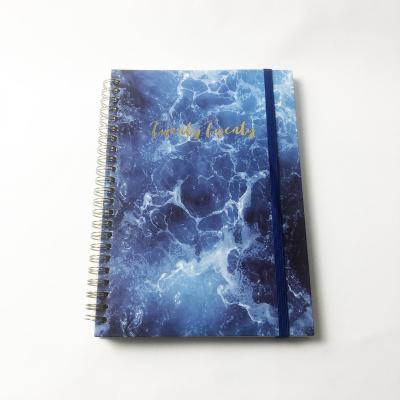 China Manufacturer Custom Printing Pattern A5 double sea gold double elastic band planner spiral blue spiral notebook for sale