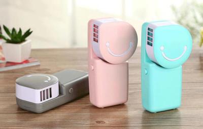 China Portable Smile Adjustable Rechargable Handheld USB Mini Air Conditiong Fan for sale