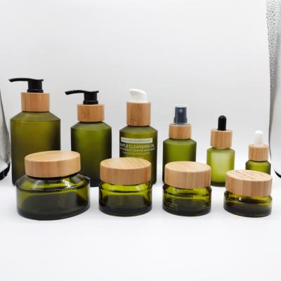 China Glass Cosmetic Bottle And Jar Set Series Shoulder Olive Oblique Bottle And Jar With Bamboo Lid/Dropper/Pump Set Products for sale