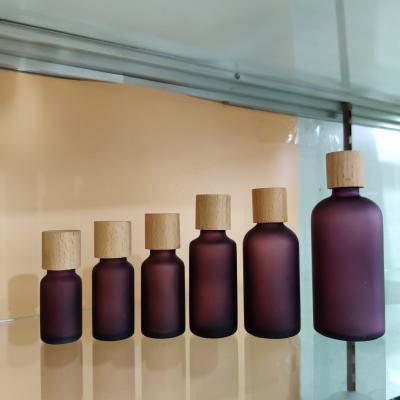 China Luxury Modern 10ML15ML20ML30ML50ML100ML Purple Frosted Glass Bottle For Essential Oil With Wooden Lid for sale