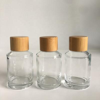 China Factory hot sale cosmetic packaging 60ml slope shoulder glass cosmetic clear bottle with bamboo screw cap for sale