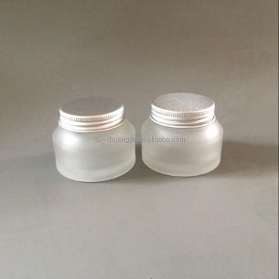 China 50ml cosmetic cosmetic frosted clear cream glass jar with silver screw lid for sale