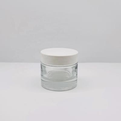 China The 50g Cosmetic Jars Series Cosmetic Glass Thick Bottom Round Clear Glass Cream Jar With White ABS Lid Products for sale