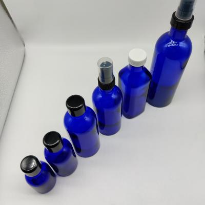 China Fashionable Unique Shaped Blue 30ml 50ml 100ml 200ml Coablt Glass Bottle For Serum Essential Oil Lotion Liquor With Rose Gold Pump for sale