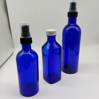 China Fashionable Unique Shaped Blue 30ml 50ml 100ml 200ml Coablt Glass Bottle For Serum Essential Oil Lotion Liquor With Rose Gold Pump for sale