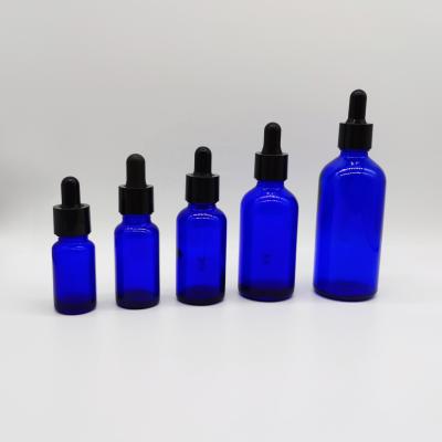 China Essential Oil Series Essential Oil Packaging Cosmetic Glass Bottle Set Blue Glass Bottle And Black Dropper for sale