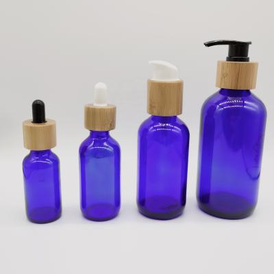 China 30ml 60ml 120ml 200ml and Bamboo Series Round Glass Water Bottles Set 30ml 60ml 120ml 200ml Blue Glass Boston Bottle Dropper Bottle for sale