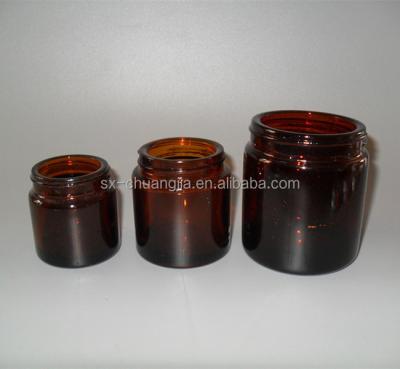 China Cylinder Amber Glass Cosmetic Cream Packaging Jar With Aluminum Silver Lid For Facial Massage for sale