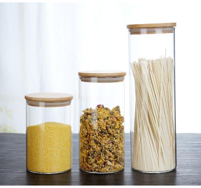 China Sustainable Kitchen Storage Bottles Round Coffee Beans Tea Spice Glass Jar Sealed Food Storage Jars With Airtight Bamboo Lid And Labels for sale