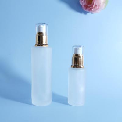 China Luxury Cosmetic 50ml 100ml Round Clear Frosted Cosmetic Lotion Container Base Bottle Glass Bottle With Pump for sale