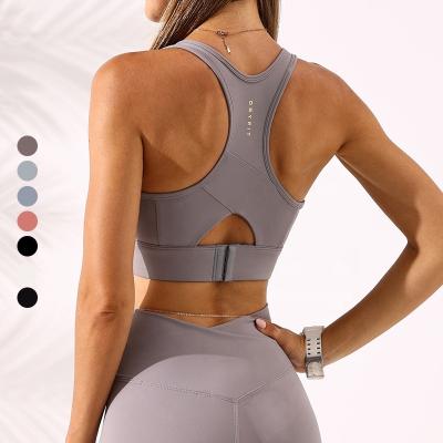 China Custom High Quality Wholesale Antibacterial Fitness Logo Solid Color Open Back Push Up Sexy Seamless Gym Yoga Cross Back Bra for sale