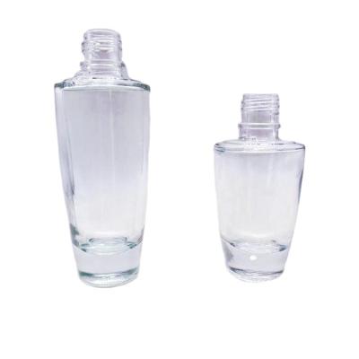 China The personal care wholesale 35ml 55ml with goloden and sliver pump cap lotion glass bottle for sale