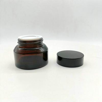 China New Design 30ml Amber Oblique Shoulder Personal Care Cream Glass Bottle With Gold And Black Cap for sale