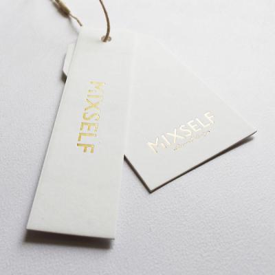 China Recyled Label Accessories Shiny Gold Foil Hang Tag , 800gsm White Thick Cardboard Paper Hang Tag For Clothing Clean Logo for sale