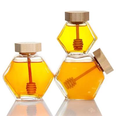 China Luxury Empty 100ml 220ml 380ml 500g Glass Hexagon Honey Bottles Jar With Wooden Dipper And Lid For Honey Packing for sale