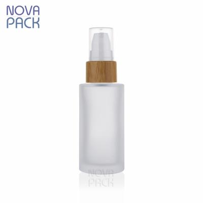 China Cosmetic Packaging 30ml 40ml 50ml 60ml Bamboo Cosmetic Cylinder Frosted Glass Bottle Serum Pump Spray Bamboo Lotion Pump Bottle for sale