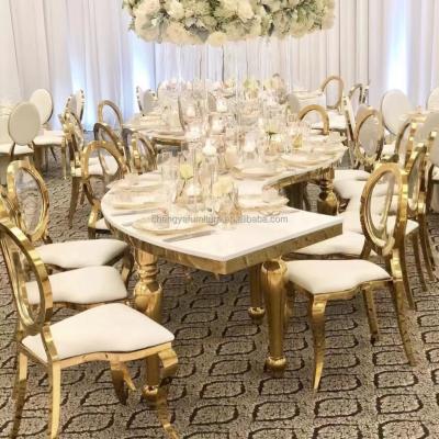 China Modern Luxury Stainless Steel Legs Glass Serpentine Table For Wedding for sale