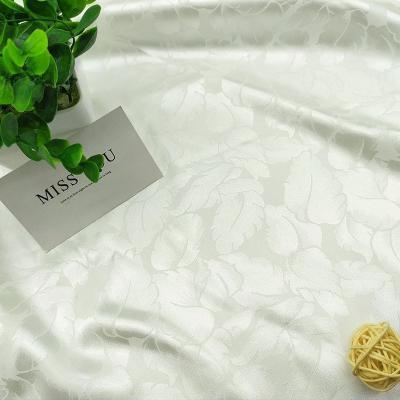 China Low price design 50d pure polyester imitation satin feather jacquard elastic fashion shirt Hanfu silk lining fabric for sale