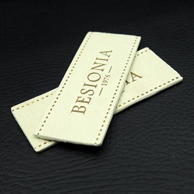 China Heat Press Logo Brown Fake Washable Custom Embossed PU Leather Jeans Brand Patch for sale