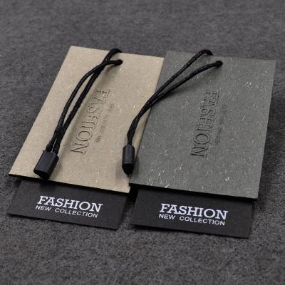 China Custom Sustainable Own Brand Logo Embossing Jeans Paper Hang Tags Customized Clothing Paper Hang Tag for sale