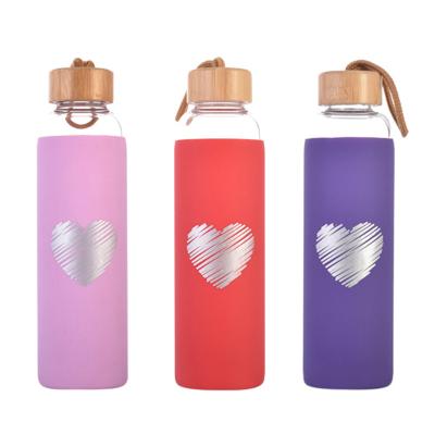 China Hot Selling Custom Viable Bulk Heart Shape Colorful Bamboo Sleeve Lid Glass Water Bottle for sale