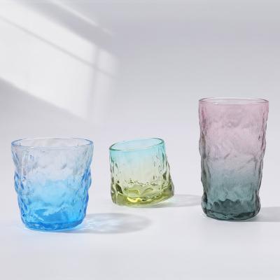 China Viable Clear Progressive Change 160ml Gradient Hammer Pattern Bottom Hemispherical Design Glass Whiskey Mug Rotating Glass Tumbler for sale