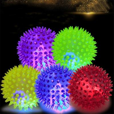 China Soft Squeaky Dog Toys Rubber Stocked Luminous Pet Puppy Chewing Hedgehog Bungee Ball with Sound Squeaker Light Ball for sale