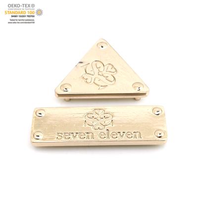 China Custom Metal Viable Logo Label With Engraved Clothing Metal Label Tag Gold Triangle Garment Logo for sale