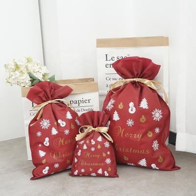 China Christmas Party Drawstring Eco Friendly Gift Disposable Packaging Pouch Red Color Non Woven Fabric Biodegradable Bags for sale