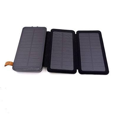 China Hot Sale 20000mAh Solar Power Bank Outdoor Indoor Outdoor Phone Charger with 3 Solar Panels and Foldable Flashlights for sale