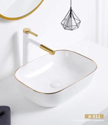 China Modern Glossy Finish Gold Trim Rectangular Ceramic Art Basin Wash Basin for sale