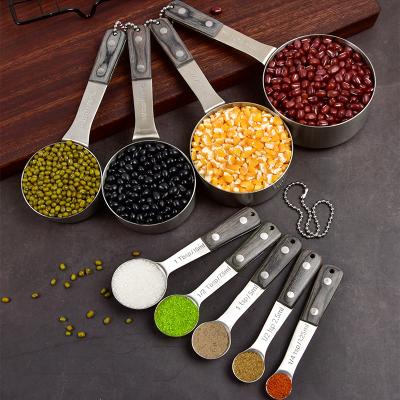 China Sustainable Stainless Steel Measuring Cups And Dosers Set With Pakka Wood Handle for sale