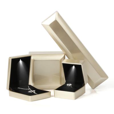 China Ornament Packaging Box Custom Logo Fashion Propose Ring Seamless Plastic Jewelry Box With LED Light for sale