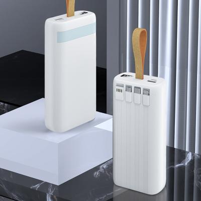 China New Arrival fast charging support four in one powerbank 30000mah wireless portable car phone wireless charger with built in cable power bank for sale