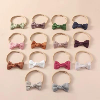 China Wholesale Canvas Bow Headband Cloth Fabric Hair Ornament Toddler Baby Nylon Knot Headbands For Baby Elastic for sale