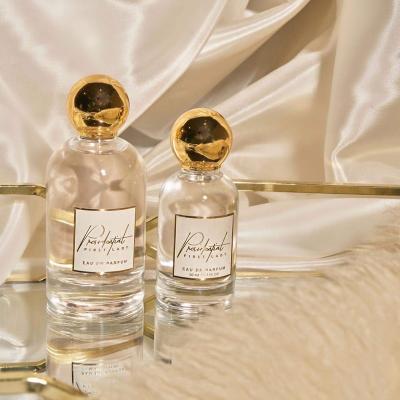 China Luxury Design OEM Round Zamac Gold Cap Glass Perfume Bottle 50ML 100ML Empty Female Luxury Perfume Bottle for sale