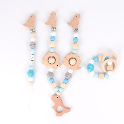 China Toy Food Grade Soft 3pcs Set Wooden Toy Teether Ring Baby Stroller Decoration Beech Wood Pendant Toy Dinosaur Pacifier Chain for sale